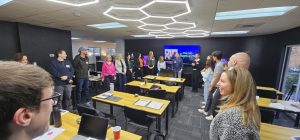 Employees practicing adaptability during an Arizona improv team-building workshop with Joe Hammer