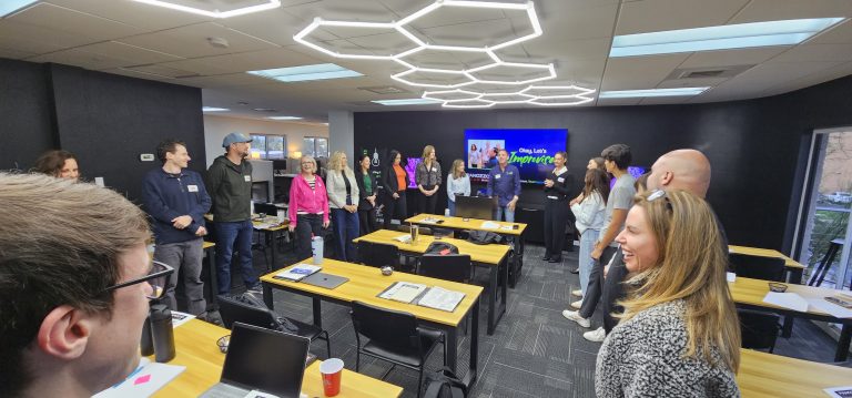Employees practicing adaptability during an Arizona improv team-building workshop with Joe Hammer
