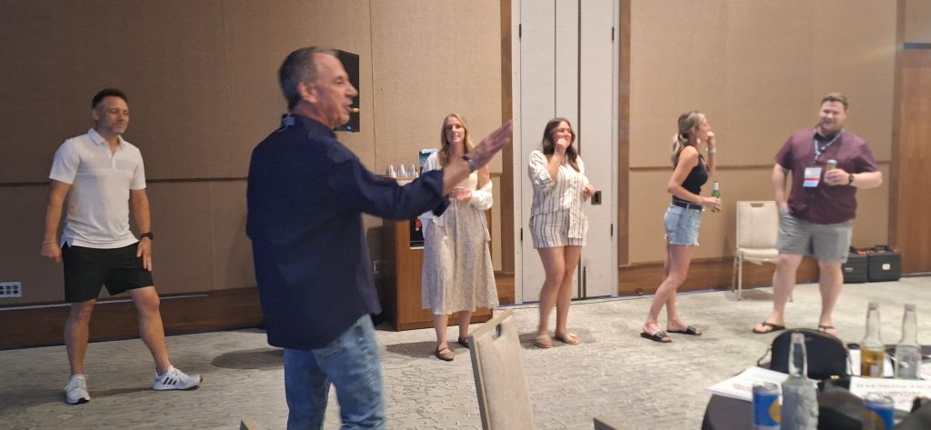 Team practicing improv training exercises with Joe Hammer to build workplace collaboration