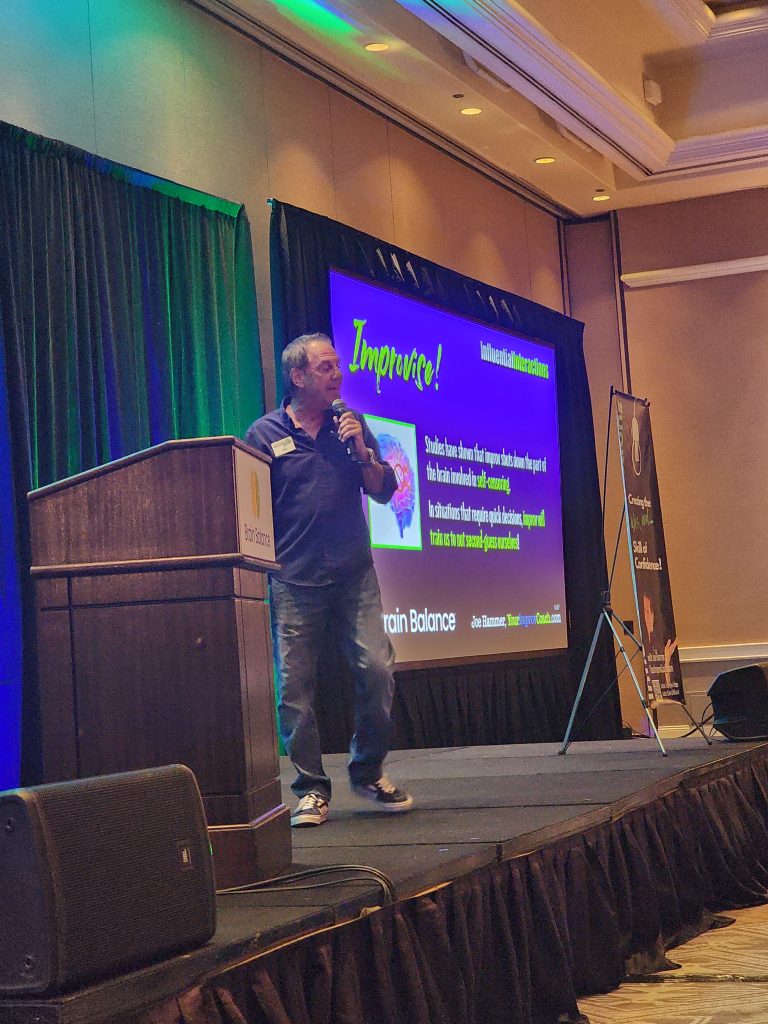 Joe Hammer leading an interactive improv session at a business conference