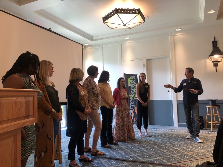 Workplace team practicing active listening exercises in an improv training session with Joe Hammer